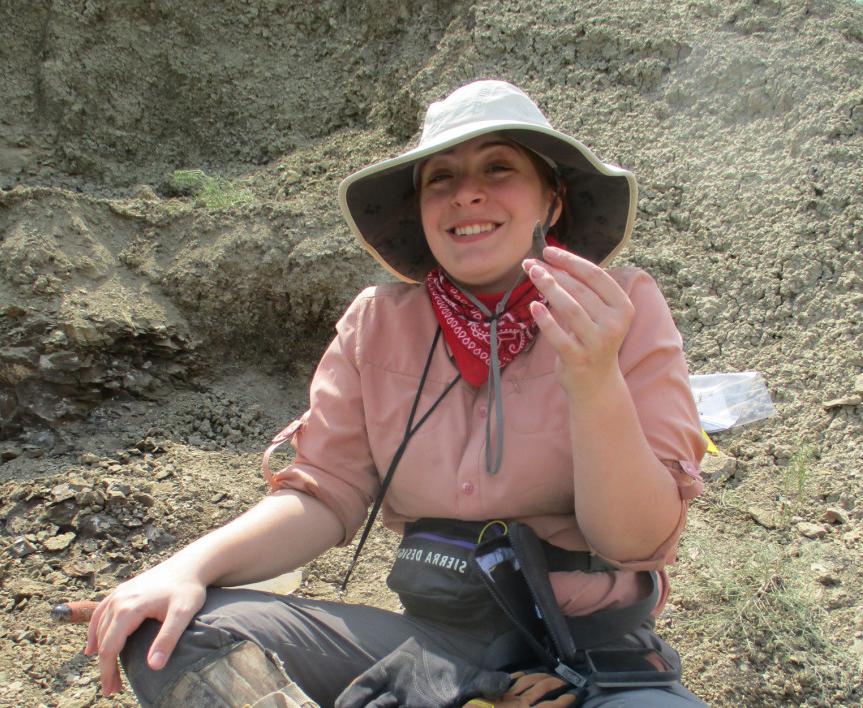 A paleontology student holding a fossil.